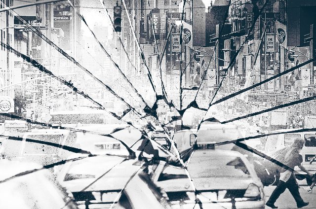Cracked window looking over the streets of NYC