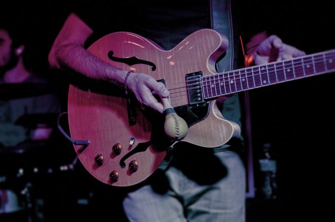 Ryan Carbary plays a Gibson electric and a shaker...at the same time.