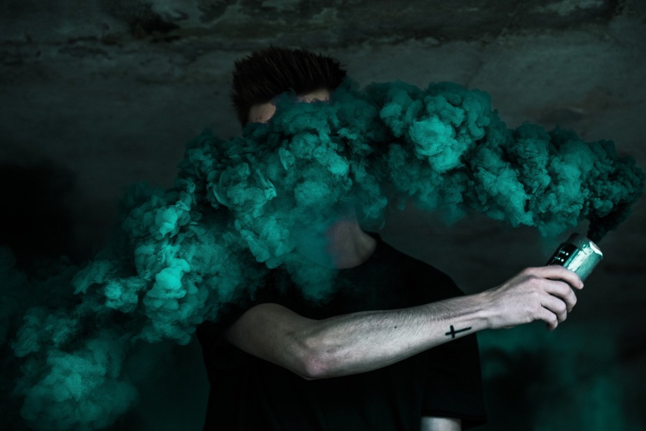 Man with thick smoke covering his face