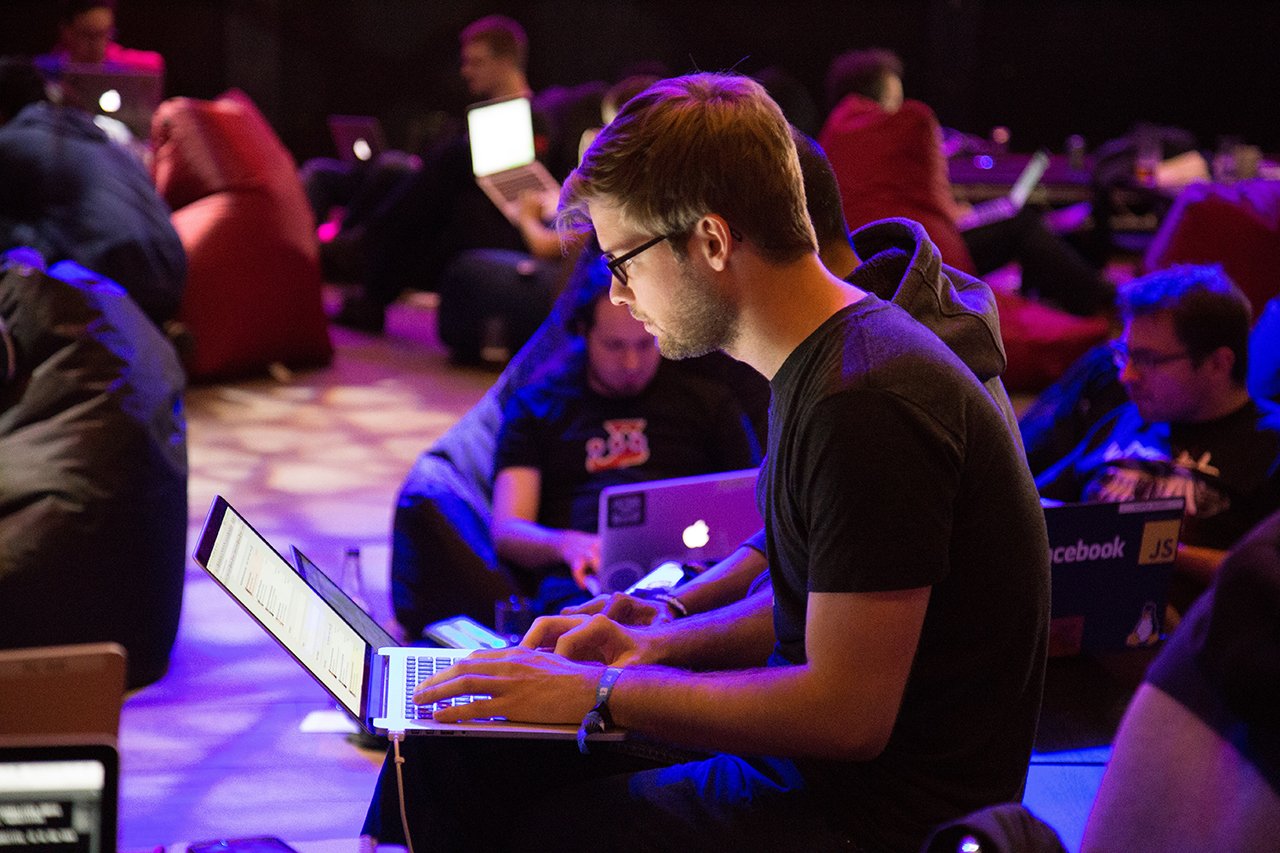 Group of people sitting in different chairs and looking at their laptops