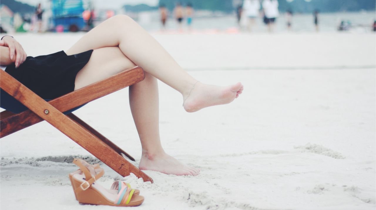 Person sitting on a chair while on the beach